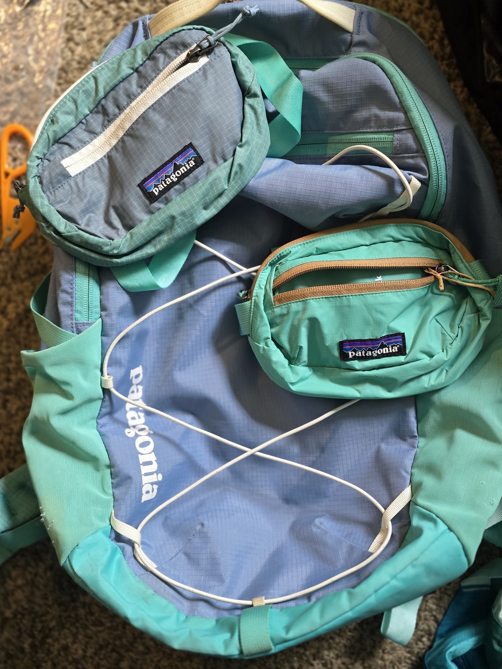Patagonia teal and light blue travel backpack with matching pouches